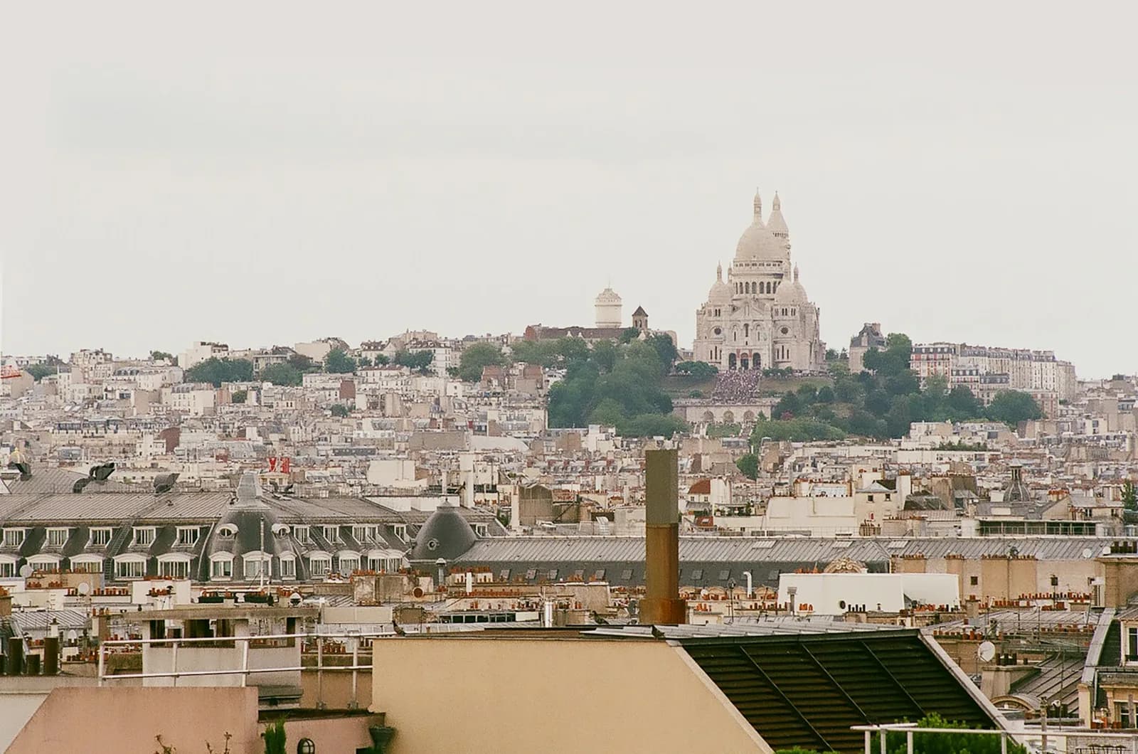Paris rooftops with Sacré Cœur above Montmartre